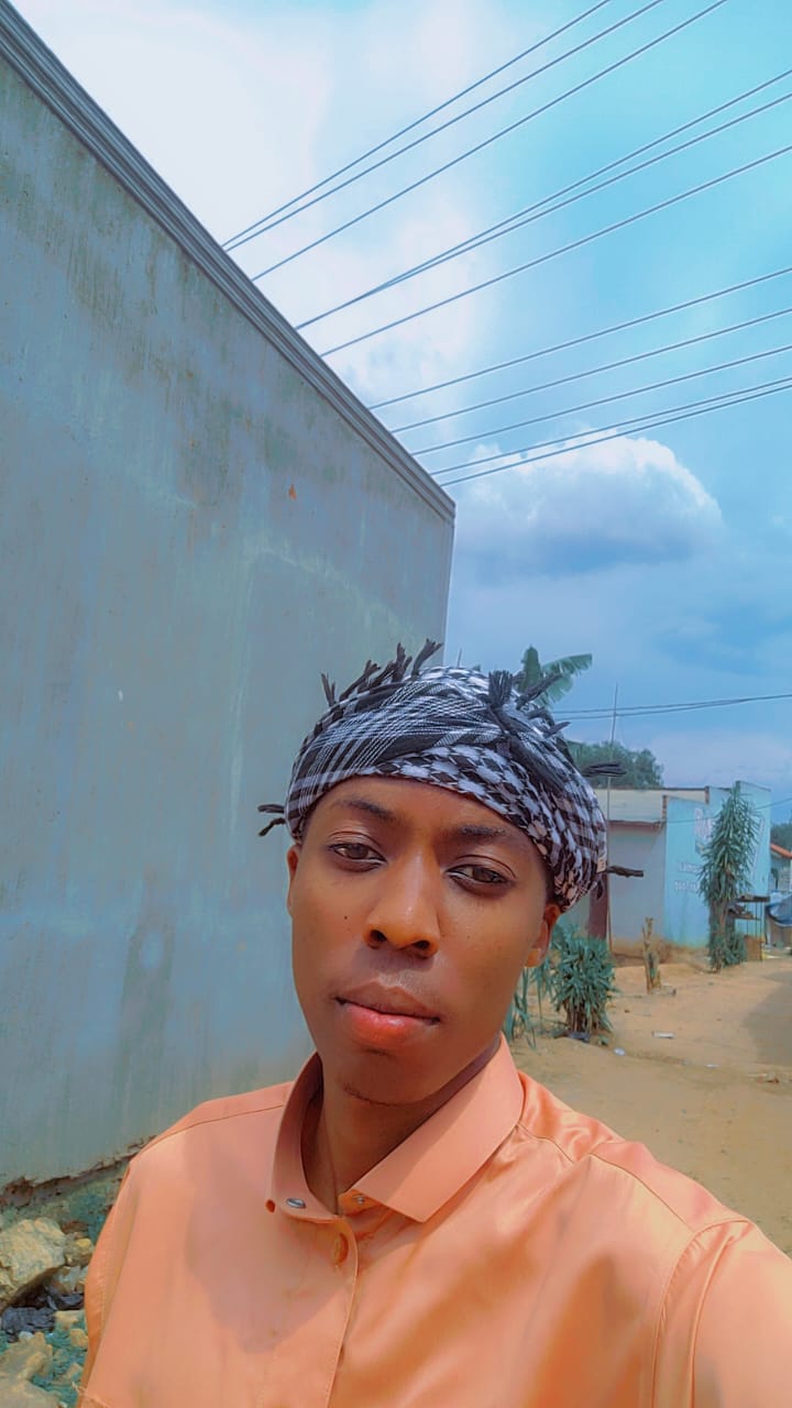 Akram Bulega in a headwrap on a street in Nansana